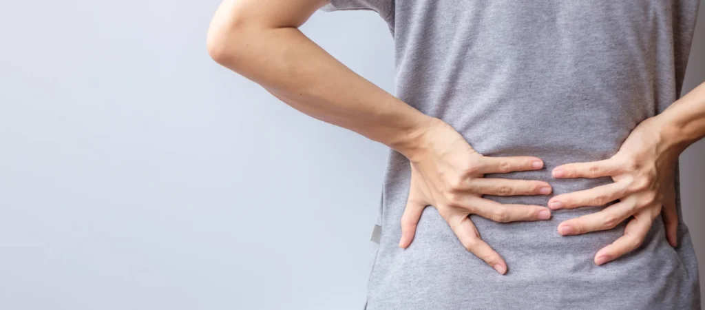 adult with hands on lower back pain 2026 03 23 23 23 55 utc